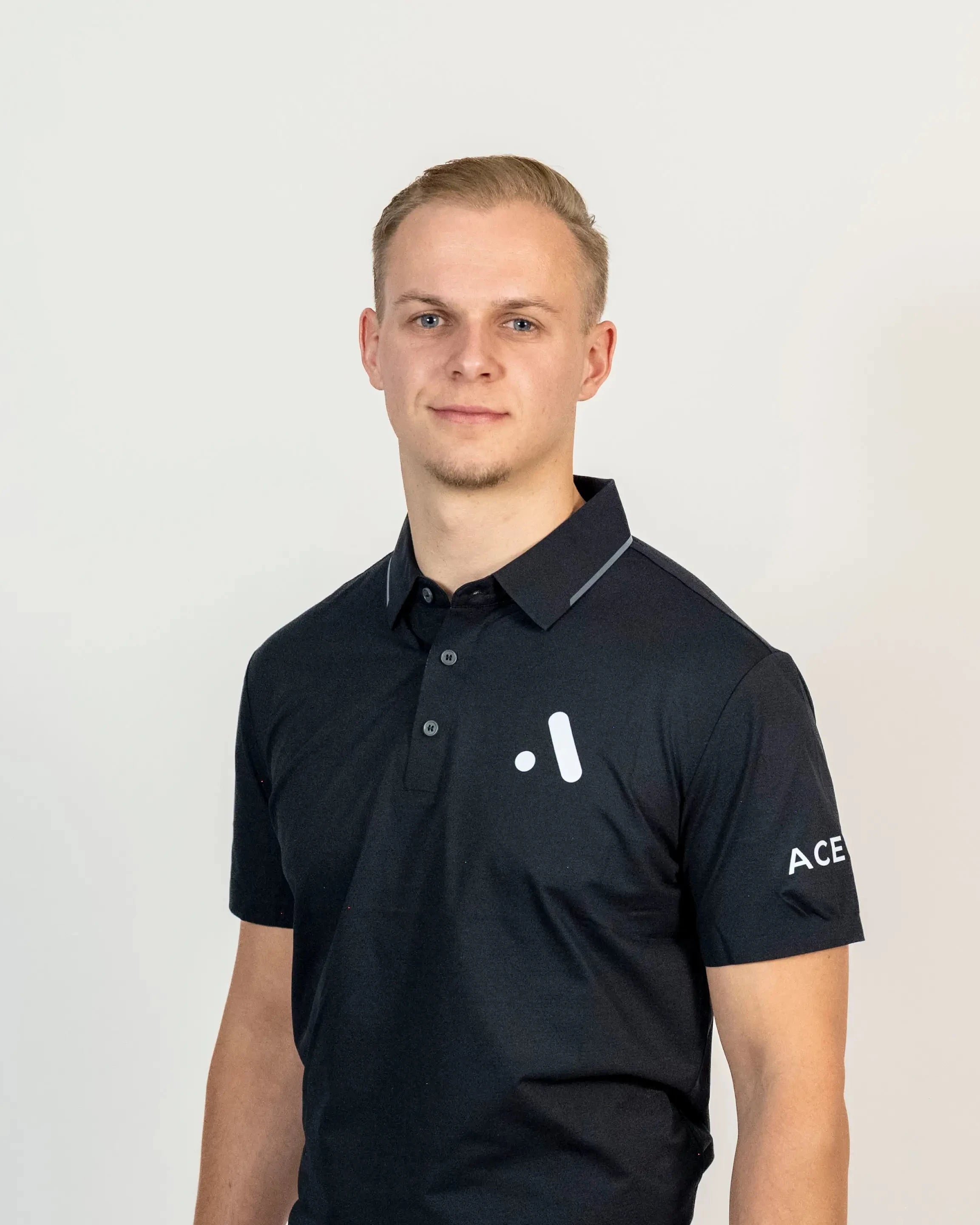 Model wearing the black Aceory Essentials polo in studio, showing modern fit and minimal design.