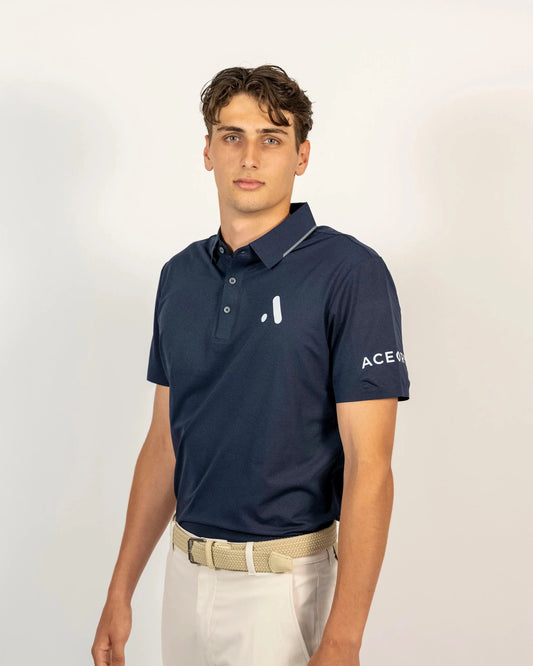 Front view of a model wearing the navy Aceory Essentials polo in studio lighting.
